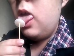 Gay teen licks and eats a lollipop made of his own cum