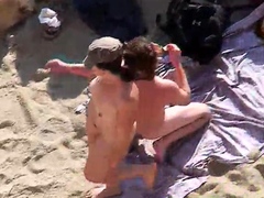 Amateur couple caught having wild sex on nudist beach